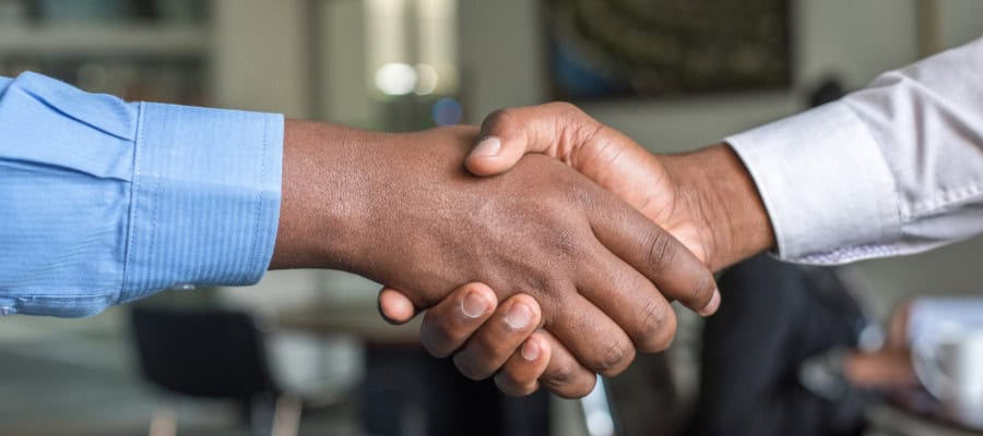 Two people shaking hands, signifying a business agreement or partnership.