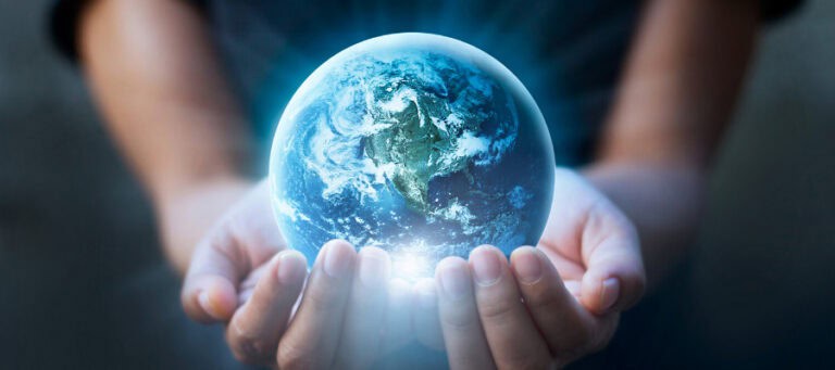 Hands gently cradling a glowing Earth globe.