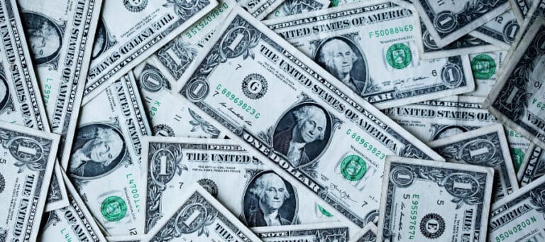 Close-up of a pile of one-dollar bills.