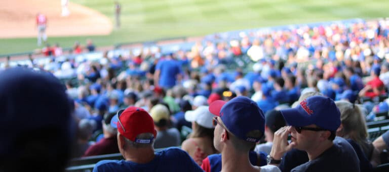 Baseball fans wearing hats at a game.
