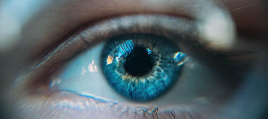Close-up of a blue eye, reflecting light.