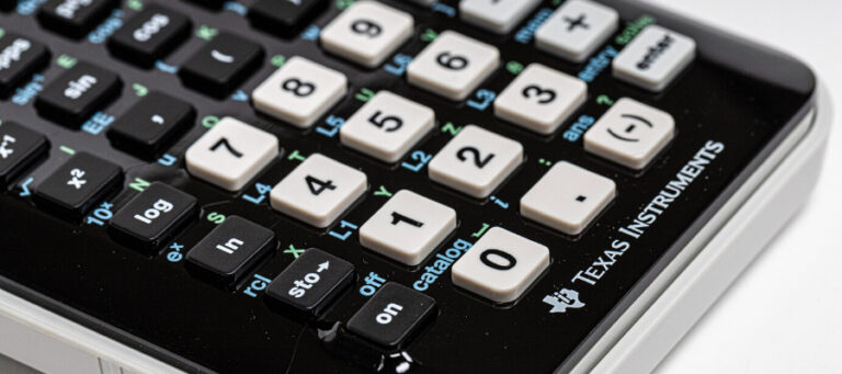 Close-up of a Texas Instruments calculator keypad.