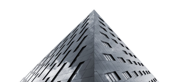 Modern triangular building against a white background.