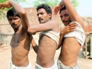 Three emaciated men with visible ribs, possibly victims of human trafficking or exploitation.