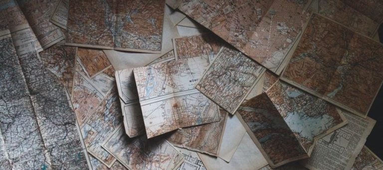 Pile of vintage maps, showing various geographical locations.