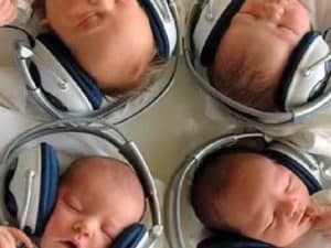 Four newborns wearing headphones, listening intently. From the Minds of Babies.