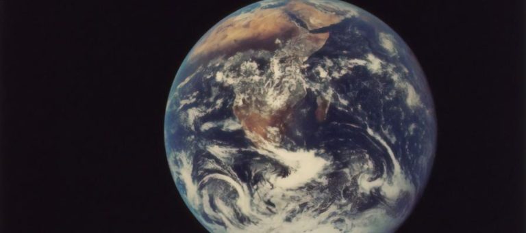 Earth from space, showing swirling clouds and continents.