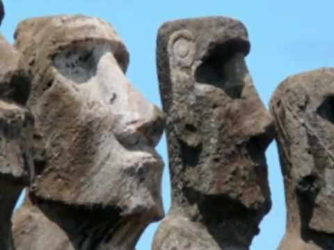 Close-up of weathered Moai statues on Easter Island, showing various facial expressions.