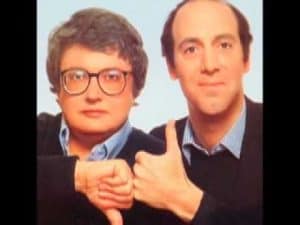 Two men, one giving a thumbs-up, the other a thumbs-down, showing disagreement.