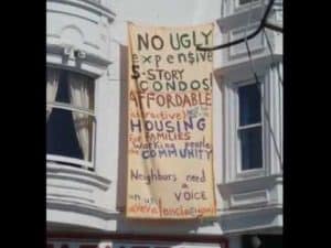 Protest banner against expensive condos, advocating for affordable housing in the community.