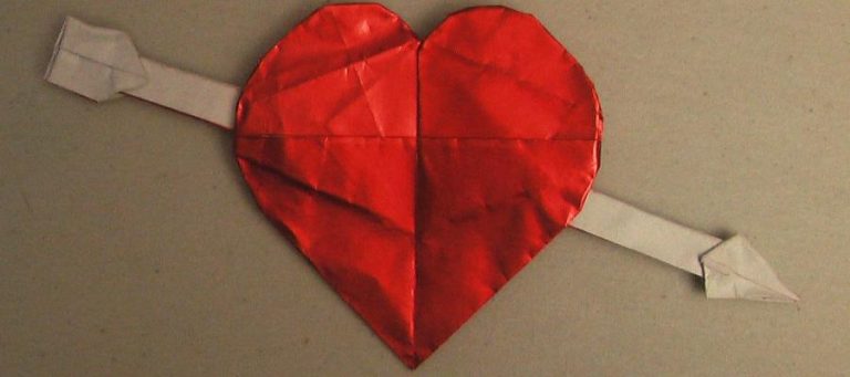 Origami heart pierced by arrow.
