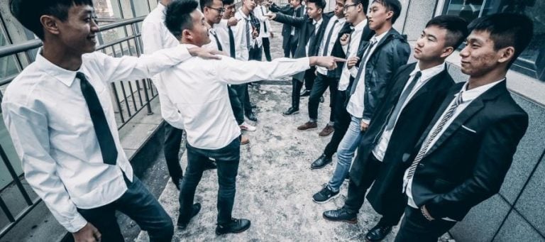 A group of young men in suits and ties, possibly discussing science, philosophy, or theology.