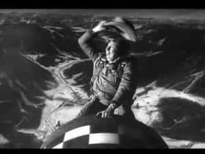 Man clinging to a bomb during a high-altitude drop, a weapon of mass destruction.