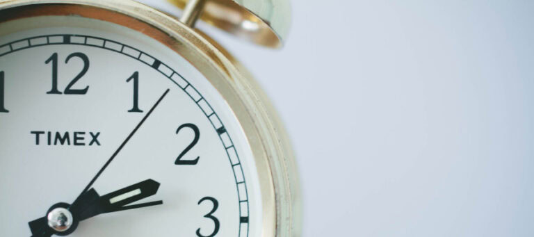 Close-up of a Timex clock showing the time of 1:58.