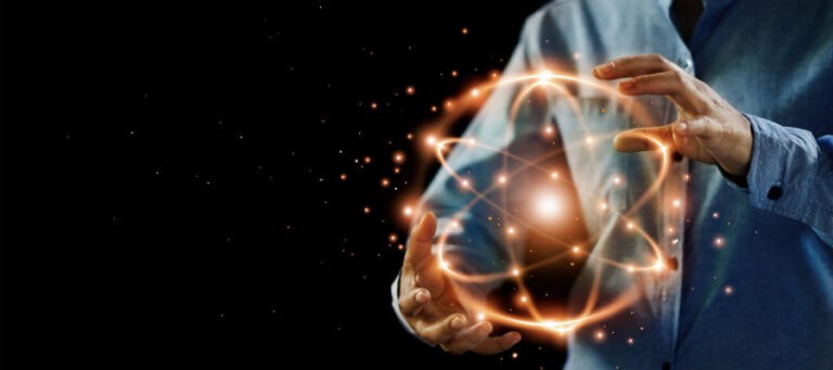 Person's hands cradling a glowing atom-like structure, symbolizing the problem of other minds.