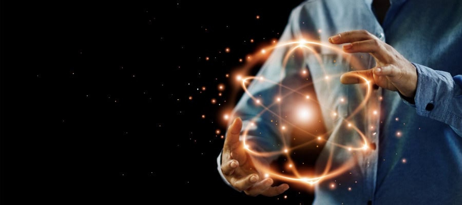 Person's hands cradling a glowing atom-like structure, symbolizing the problem of other minds.