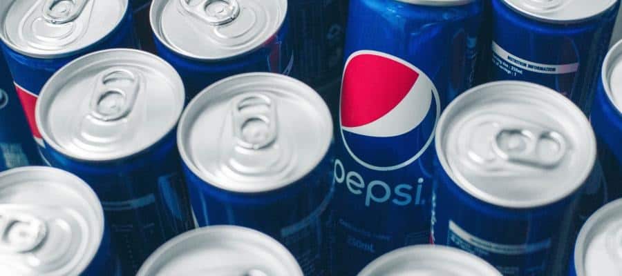 Close-up of several Pepsi cans. The Pepsi logo is clearly visible.