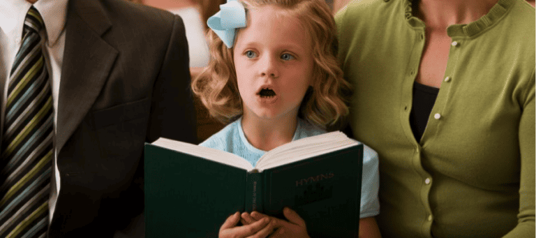 Young girl singing from a hymn book during church service.