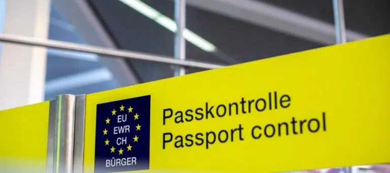 Passport control sign in German and English. EU, EWR, CH symbols.