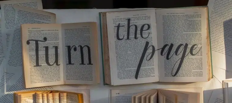 Open books with "Turn the page" text overlay. Evolution of storytelling.