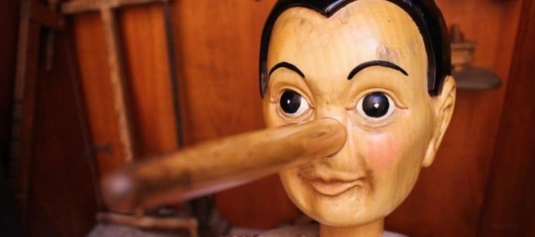 Wooden Pinocchio figurine with a long nose, illustrating the evolution of storytelling through iconic characters.