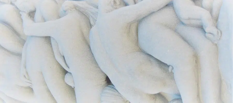Abstract marble sculpture depicting intertwined figures, illustrating the evolution of storytelling through human connection.