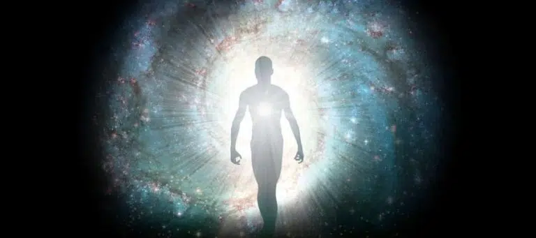 Silhouette of a person walking toward a bright light, representing spiritual ascension or enlightenment.