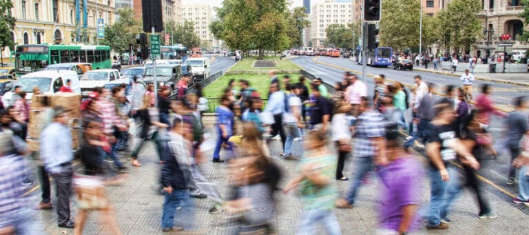 Blurred crowd of people walking on a city street, illustrating the diversity of humanity.