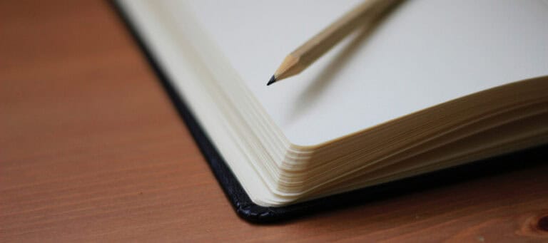 Open notebook with pencil, suggesting contemplation of inherent human worth.