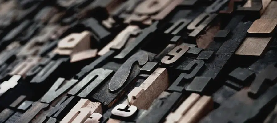 Close-up of vintage printing blocks, showcasing various letters and numbers.