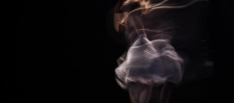 Motion-blurred ballerina in a flowing tutu, expressing dance as a way of knowing.