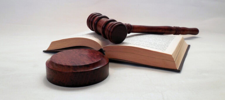 Gavel and law book; concepts of safe space.