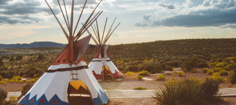 Two decorated teepees on a desert landscape. Concepts of safe space.