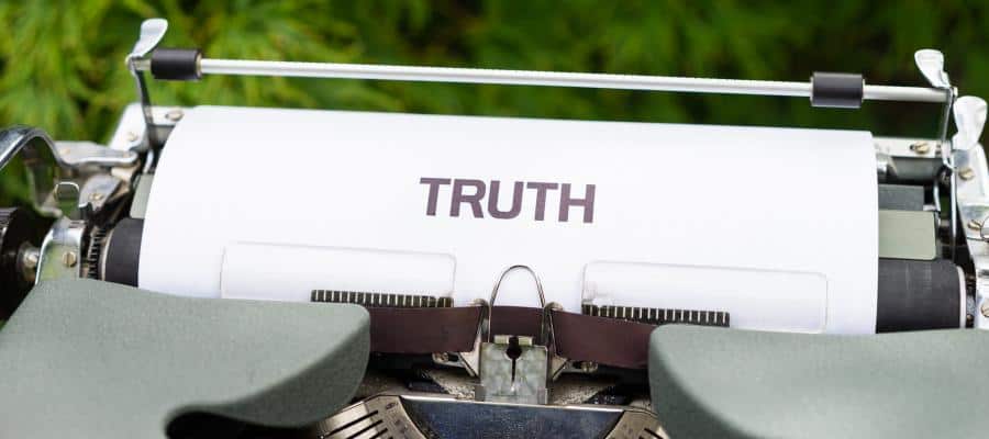 Vintage typewriter with paper that reads "TRUTH".
