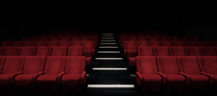 Empty red movie theater seats and aisle