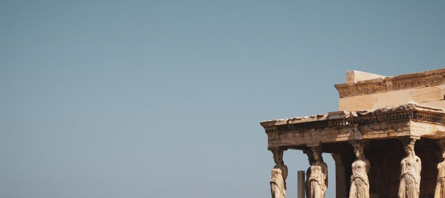 Ancient Greek Caryatid statues supporting the Erechtheion temple on the Acropolis in Athens.