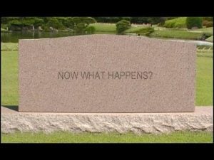 Headstone inscribed "Now What Happens?