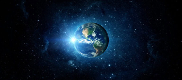 Earth from space, sun rising over North and South America.