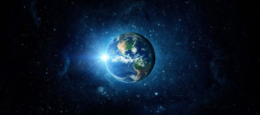 Earth from space, sun rising over North and South America.