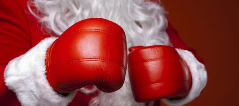 Santa Claus wearing red boxing gloves