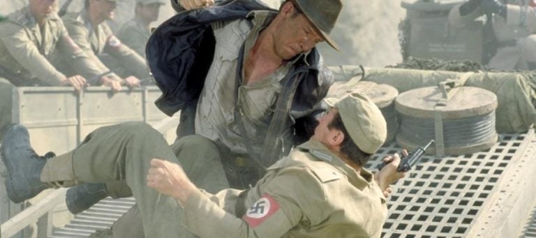 Indiana Jones fighting a Nazi soldier on a truck.