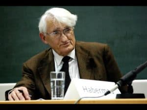 Jürgen Habermas at a conference, "Habermas" nameplate visible.
