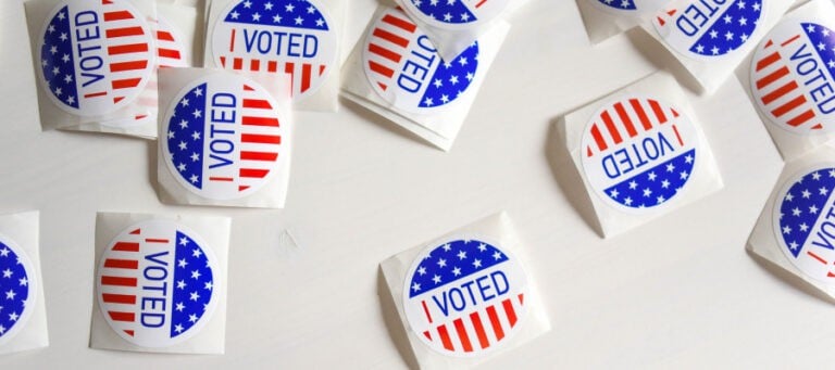 Several "I Voted" stickers on a white surface.