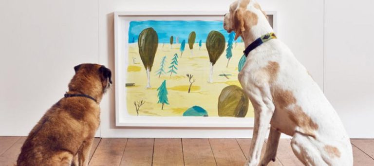 Two dogs view a landscape painting.