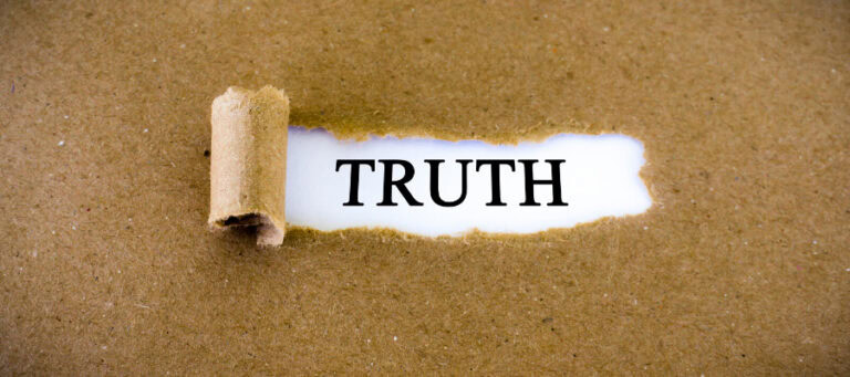 Torn paper revealing the word TRUTH.