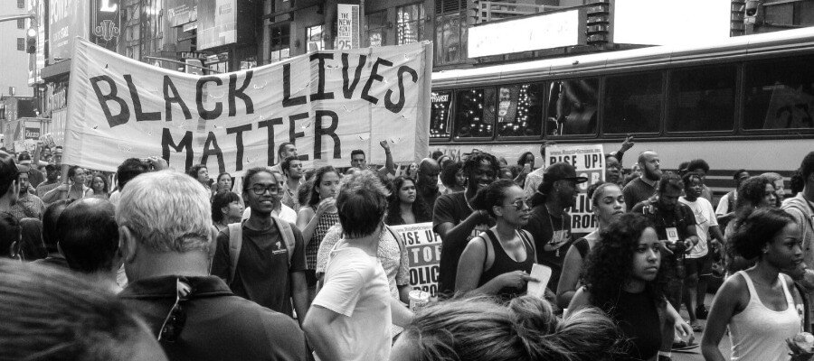 Black Lives Matter protest in New York City. "Black Lives Matter" banner visible.
