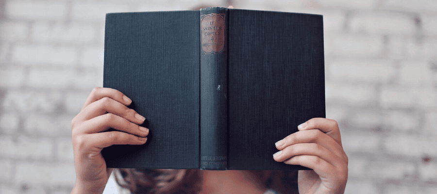 Person holding a book titled "If Winter Comes." Midlife crisis reflection.