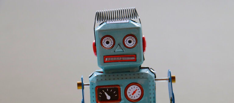 Vintage tin robot toy with gauges and expressive face.