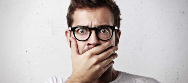 Shocked man covering his mouth with hand