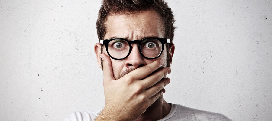 Shocked man covering his mouth with hand